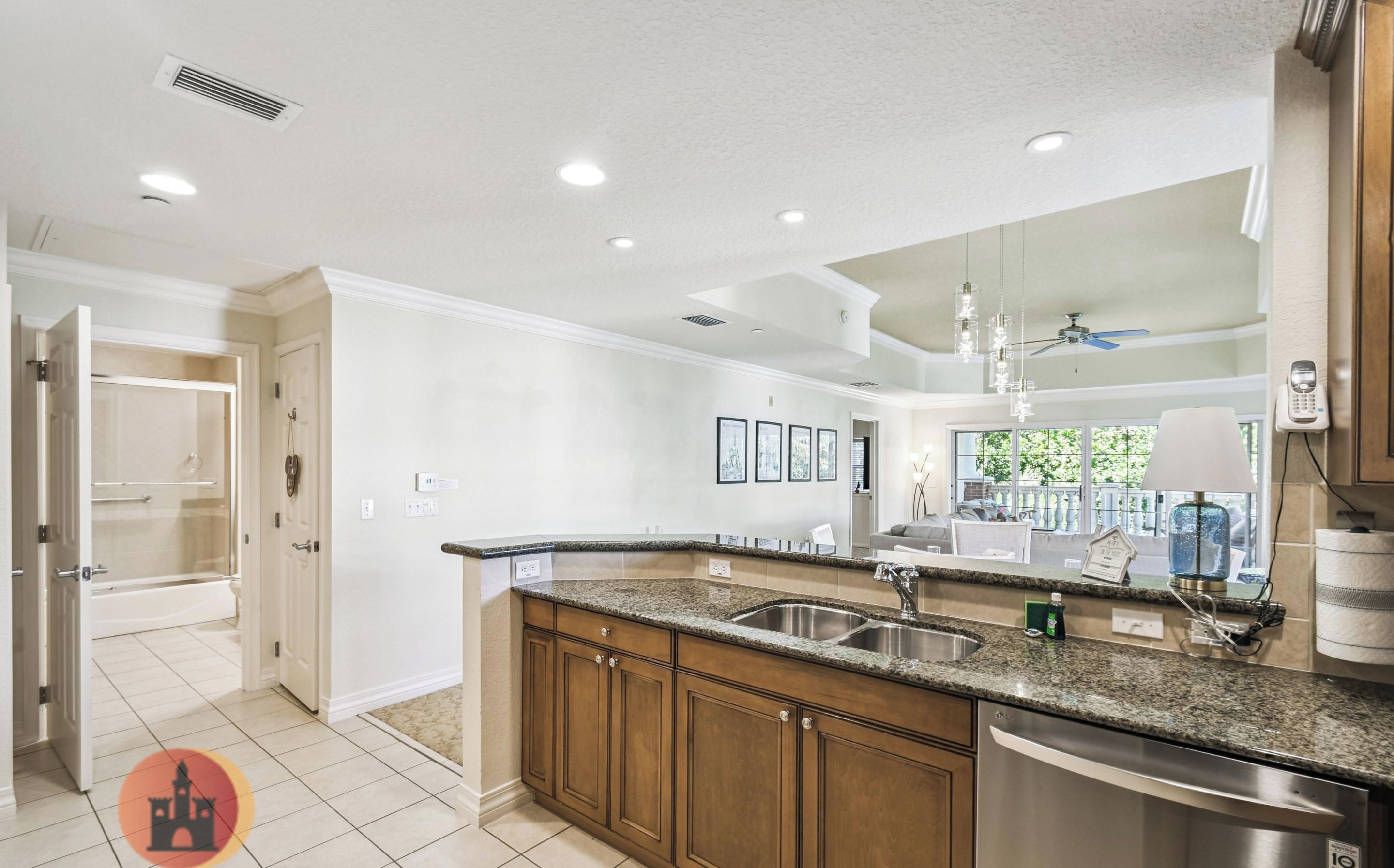 A modern kitchen with granite countertops, stainless steel appliances, and wooden cabinets.