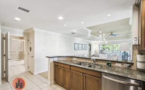 A modern kitchen with granite countertops, stainless steel appliances, and wooden cabinets. - Heaven On Earth Private Home (Kissimmee)