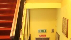 A staircase with red carpet leading to an elevator. - hotel cordova (Florence)