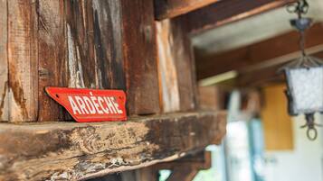 Una struttura in legno rustica con un cartello rosso che riporta la scritta 'ARDECHE'.