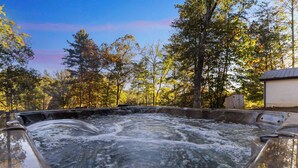 A hot tub surrounded by trees with a clear sky. - The Sugarcreek Farmhouse•Hot Tub|Theater|Fire Pit (Blue Ridge)