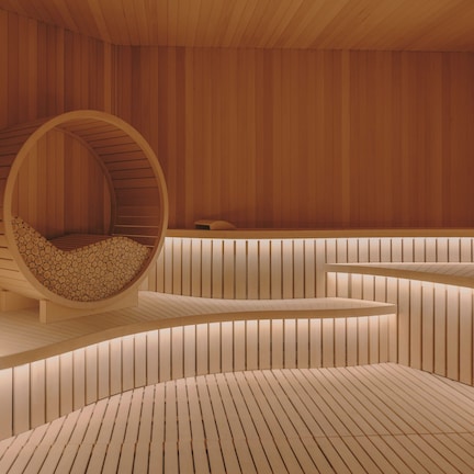 A modern interior with a circular seating area, wooden paneling, and a curved bench.