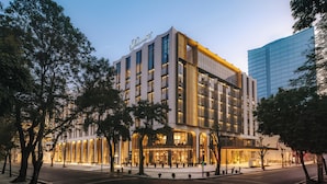 A modern hotel with a prominent 'Fairmont' sign, large windows, and a well-lit entrance. - Fairmont Hanoi (Hanoi)