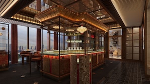 A luxurious interior with a bar area, large windows offering city views, and ornate ceiling details. - Fairmont Hanoi (Hanoi)