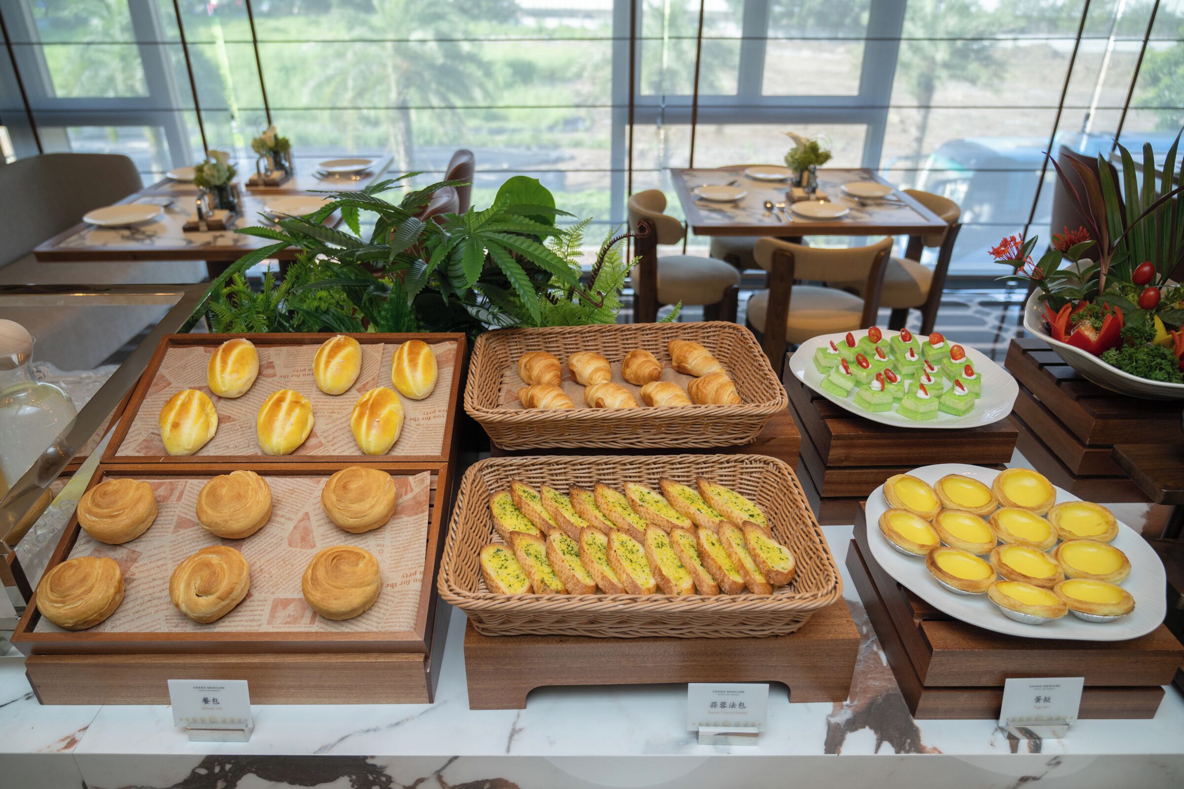 A bakery display with various pastries and bread.
