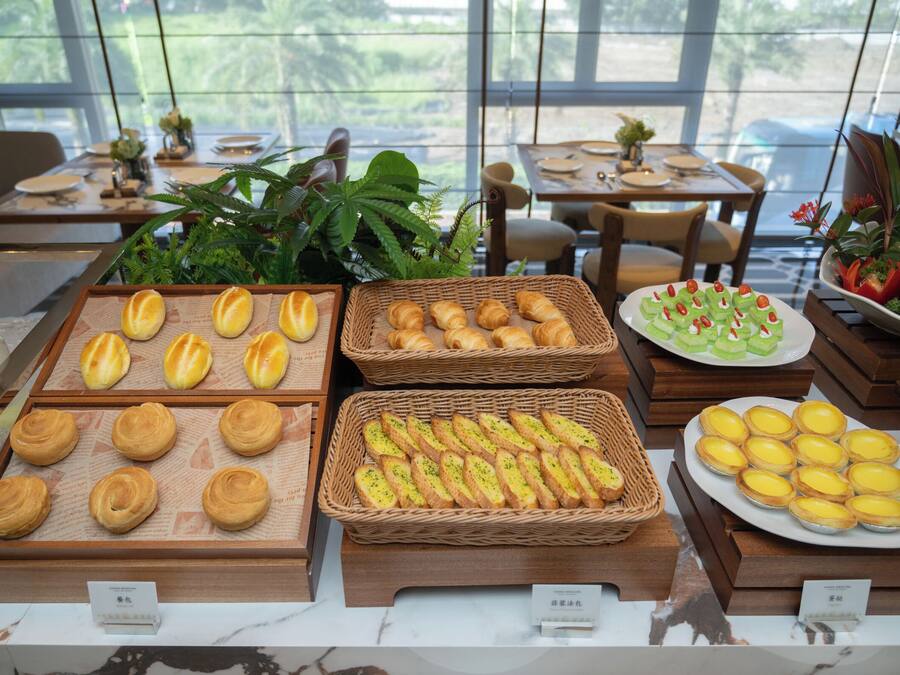 A bakery display with various pastries and bread.