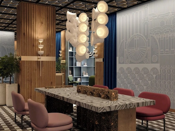 A modern interior with a marble table, red chairs, and a unique ceiling design. - Mövenpick Yerevan (Yerevan)