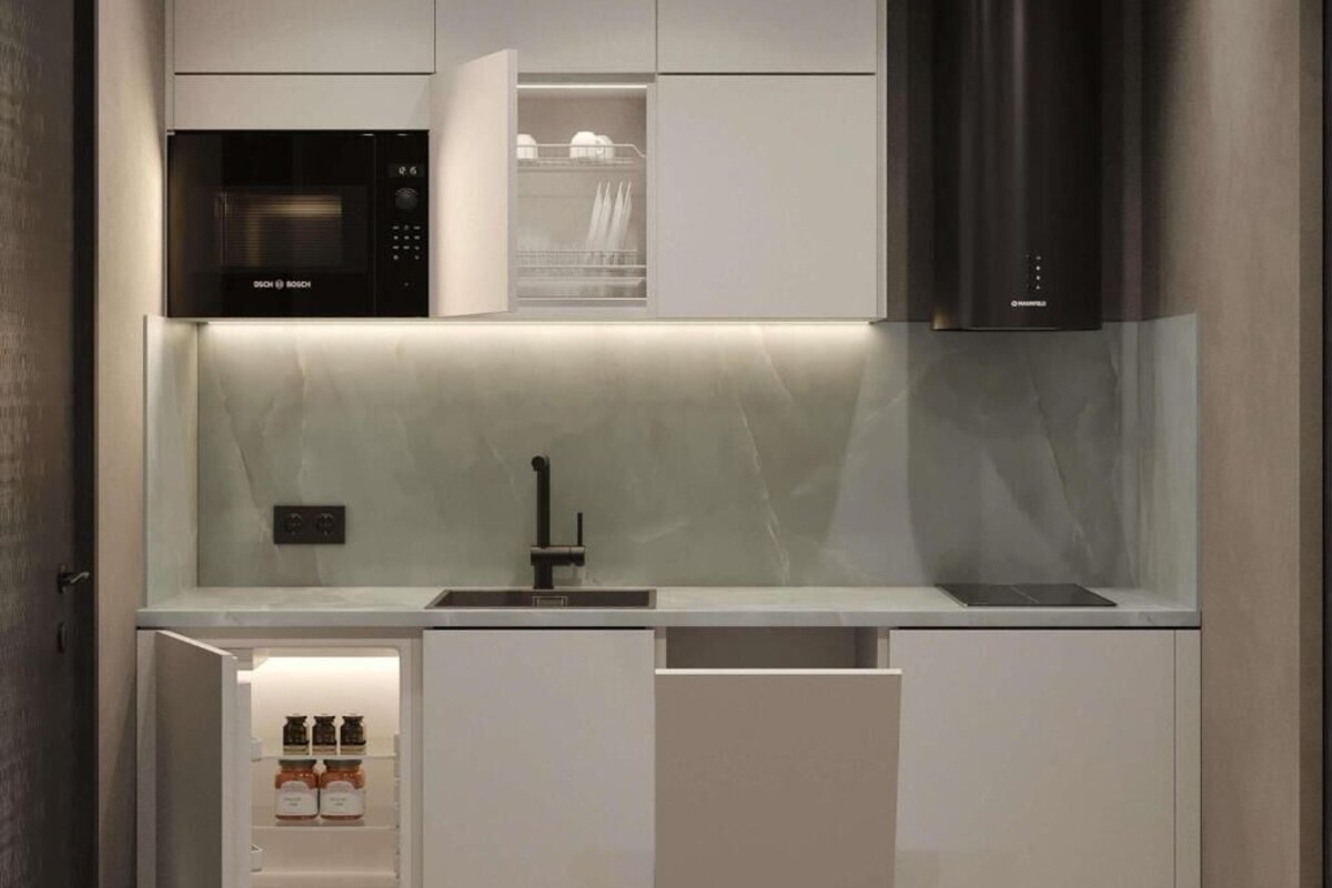 A modern kitchen with a Bosch microwave, a built-in sink, and a stainless steel range hood.