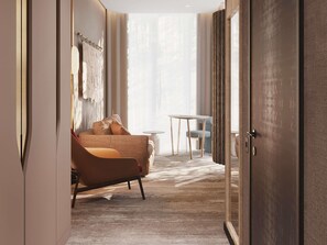 A hotel room with a sofa, a small table, and a chair. - Mövenpick Yerevan (Yerevan)