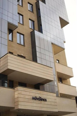 A multi-story building with a modern architectural design, featuring balconies and a prominent 'MOVENTICK' sign. - Mövenpick Yerevan (Yerevan)