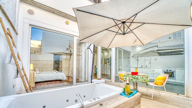 A modern bathroom with a large bathtub, a shower, and a glass-enclosed shower area. - Modern house Menut in Sa Pobla with jacuzzi (Sa Pobla)