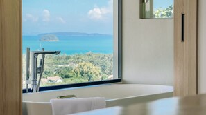 A modern bathroom with a large window offering a view of a coastal landscape. - The Salin Seaview Villas (Rawai)