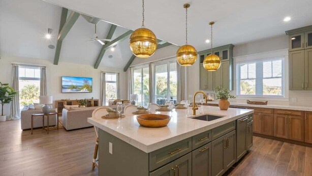 A spacious kitchen with a large island, pendant lighting, and a view of the outdoors. - Elegance~Gorgeous! Arcade!~ Heated pool/spa~North End! (Anna Maria)