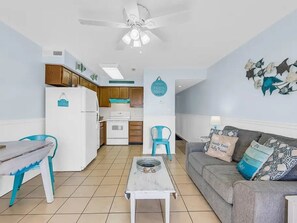 A compact living space with a kitchenette, a dining area, and a seating area.