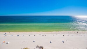 A beach with clear blue water and a sandy shore. - Phoenix Orange Beach 1602 3 Bedroom Condo (Orange Beach)