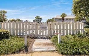 A wooden gate with a sign indicating it's for owners and guests of Beachwood Villas, with a pathway leading to the property. - Seagrove -  Community Pool - Steps To The Beach (Santa Rosa Beach)