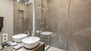 A modern bathroom with two large sinks, a glass-enclosed shower, and a marble-tiled wall. - Exceptional Appt - Saint-germain- Mobility Lease (Paris)