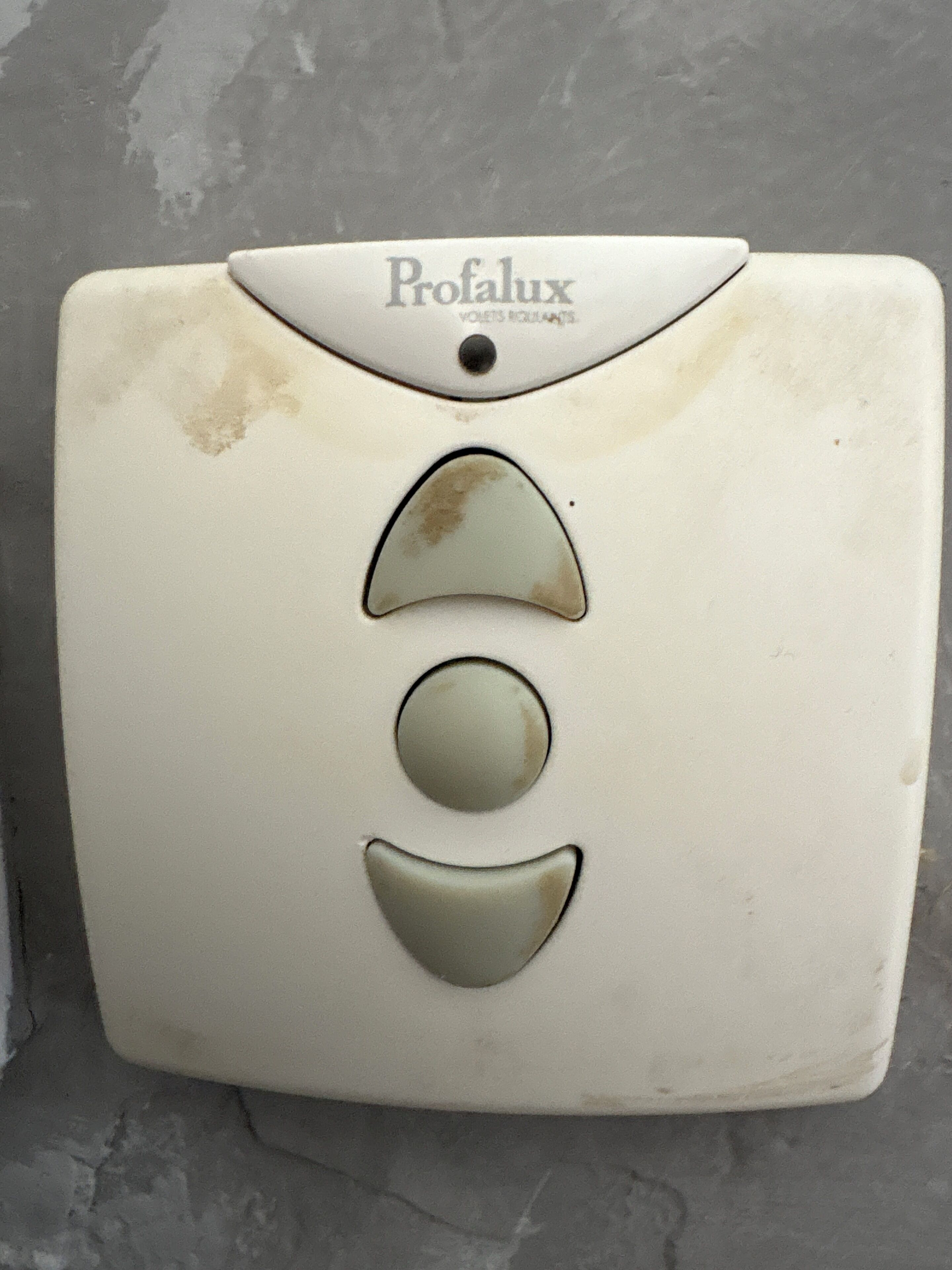A white square-shaped object with the brand name "Profalux" and three circular indentations.