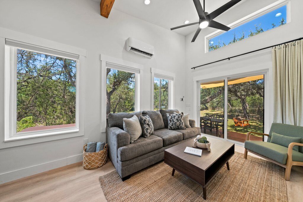 Living room featuring large windows with lots of natural light.