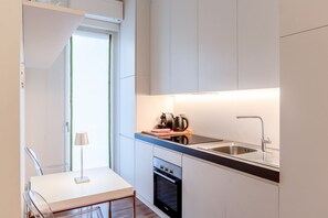 A modern kitchen with a built-in oven, a sink, and a countertop.