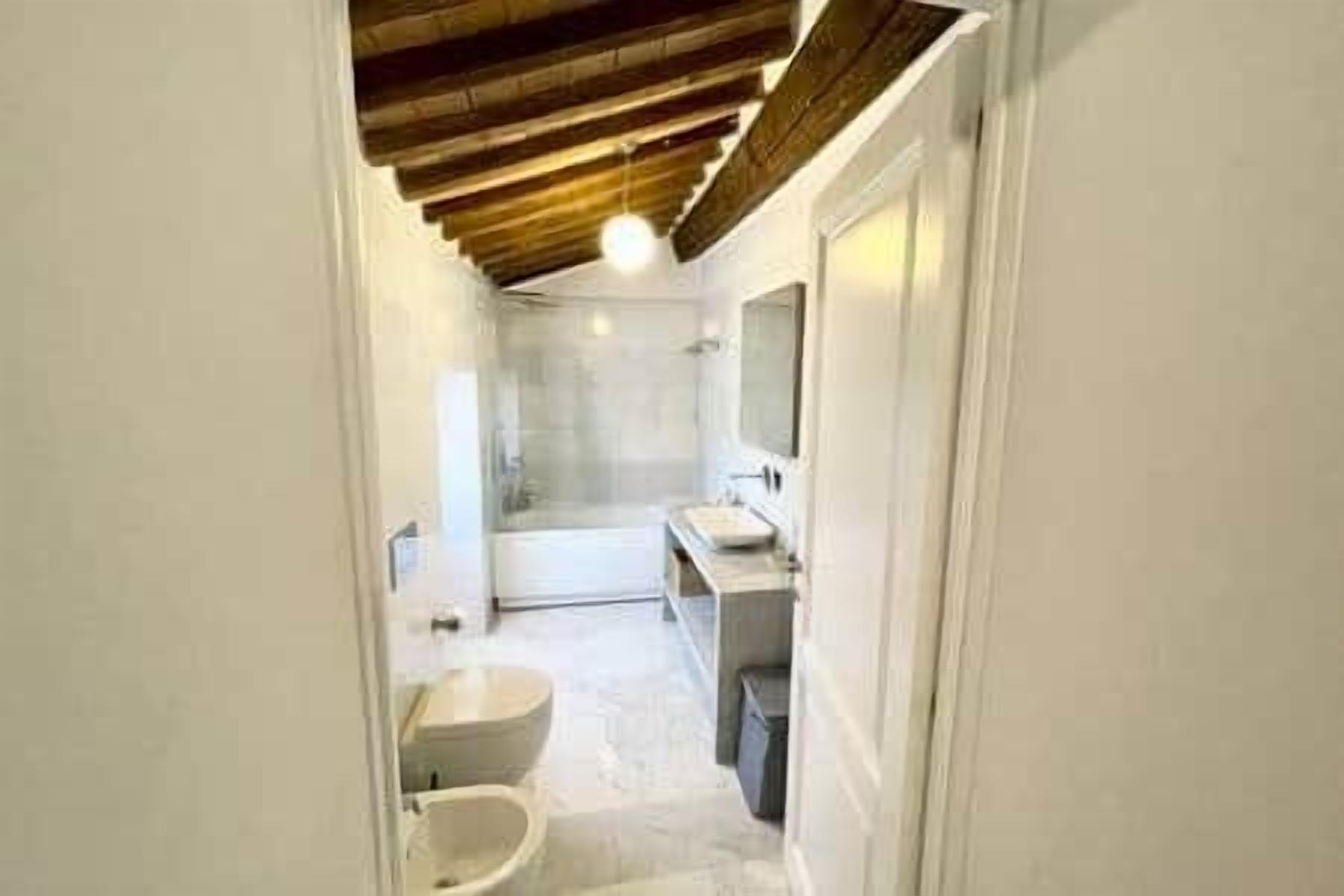 A bathroom with a toilet, bidet, and sink.