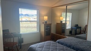 A bedroom with two beds, a desk, a chair, a wardrobe, and a large mirror. - Great Space for Relaxing, Roomy House. Trailer Parking Plentiful, 3 Acres (South Fork)