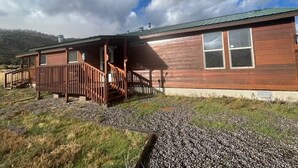 A wooden cabin with a porch and a gravel driveway. - Great Space for Relaxing, Roomy House. Trailer Parking Plentiful, 3 Acres (South Fork)