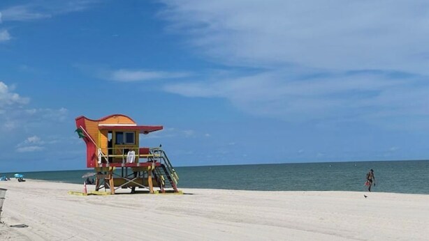A lifeguard tower on a beach with a clear sky. - #02 Unit in Mid-century Art-Déco Building KingBed EnSuiteBath Steps>Beach PetsOK (Miami Beach)