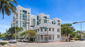 A modern hotel with a white facade, multiple balconies, and a green street sign indicating 'Hording Ave'. - #04 Corner Unit in Mid-century Art-Déco building KingBed EnSuiteBath PetsOK (Miami Beach)