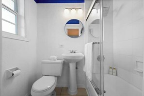 A bathroom with a toilet, sink, and shower. - #05 Corner Unit in Mid-century Art-Déco Building KingBed EnSuiteBath Steps>Beach (Miami Beach)