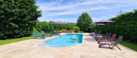 Seasonal outdoor pool, open 10:00 AM to 9:00 PM, pool umbrellas