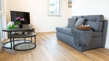 Departamento Confort, vista al resort | Área de sala de estar