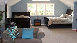 A bedroom with two beds, a window, a nightstand, a lamp, and a decorative vase. - Creekside Loft + Allstar Deluxe (Otego)