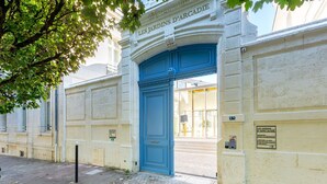 An entrance to a building with a blue door and a sign reading "LES JARDINS D'ARCADIE". - Résidence de Bourges (Bourges)