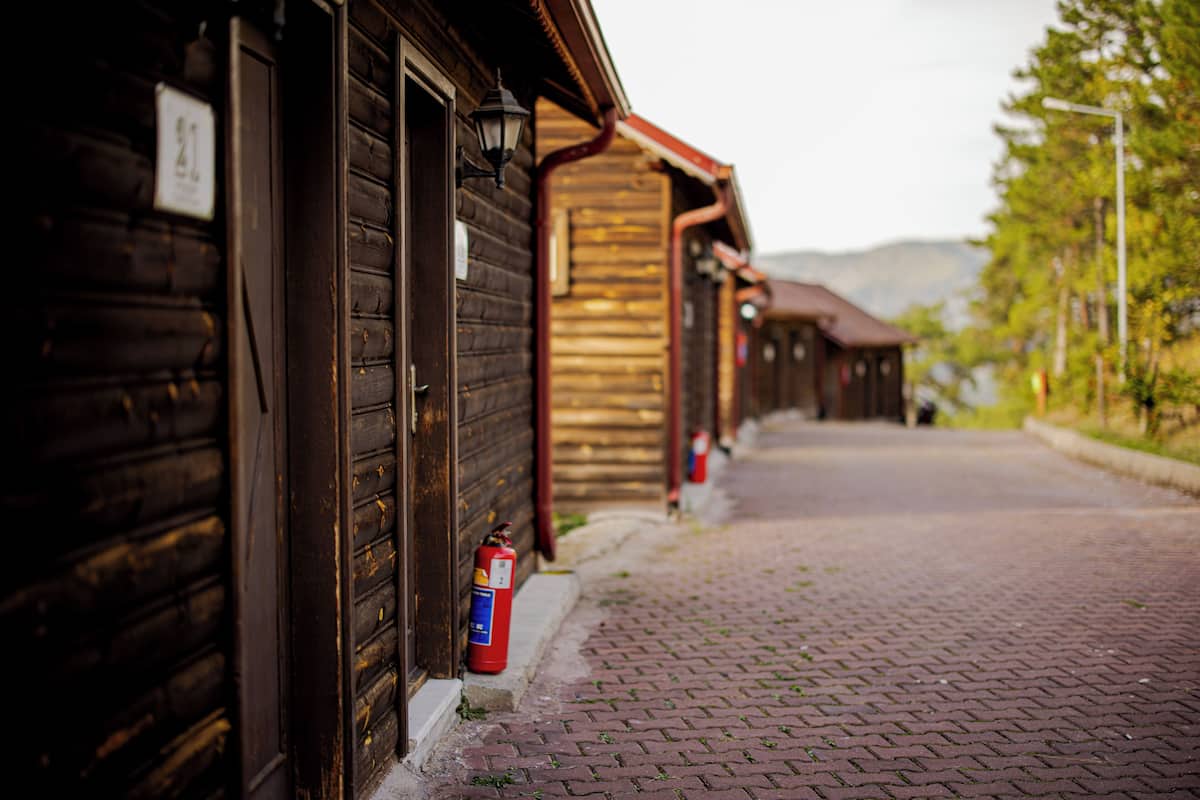 A wooden building with a brick pathway leading to it.