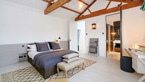 A bedroom with a large bed, bedside tables, a desk, and a wardrobe. - Super premium - Cadogan Square 3 bedroom apartment (London)