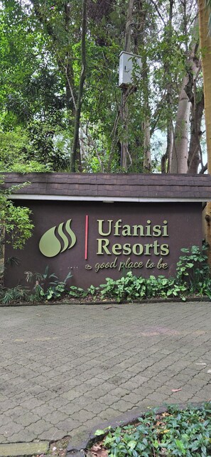 Segnale per Ufanisi Resorts, con logo e la frase 'luogo ideale'.