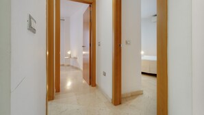 Un pasillo con una puerta de madera que da a un dormitorio.