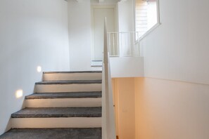 A staircase with white walls and a door at the top. - On My Way Loft-Central Rooftop Apt with AC/Terrace (Como)