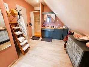 A modern kitchen with a built-in oven, a sink, and a countertop with various appliances.
