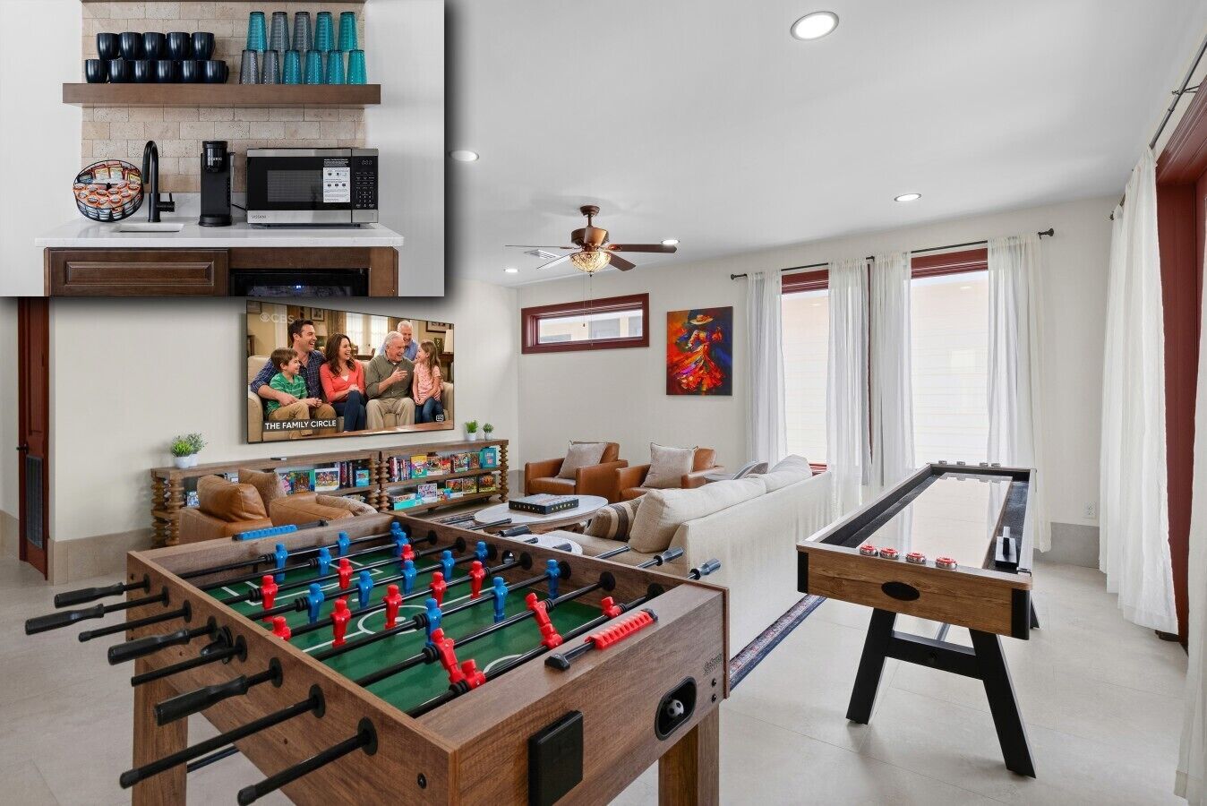 A living room with a foosball table, a television, and a bookshelf.