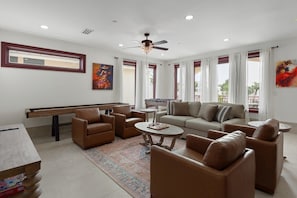 A spacious living area with a pool table, sofa, chairs, and a ceiling fan. - Saltwater spa & pool, Beach@3min walk, Golf cart, Elevator (Destin)