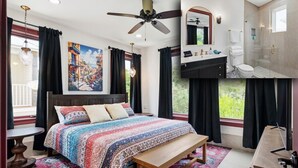 Une chambre à coucher comprenant un lit, un banc, un ventilateur de plafond, une fenêtre avec des rideaux, une salle de bain avec une douche et un tableau accroché au mur.