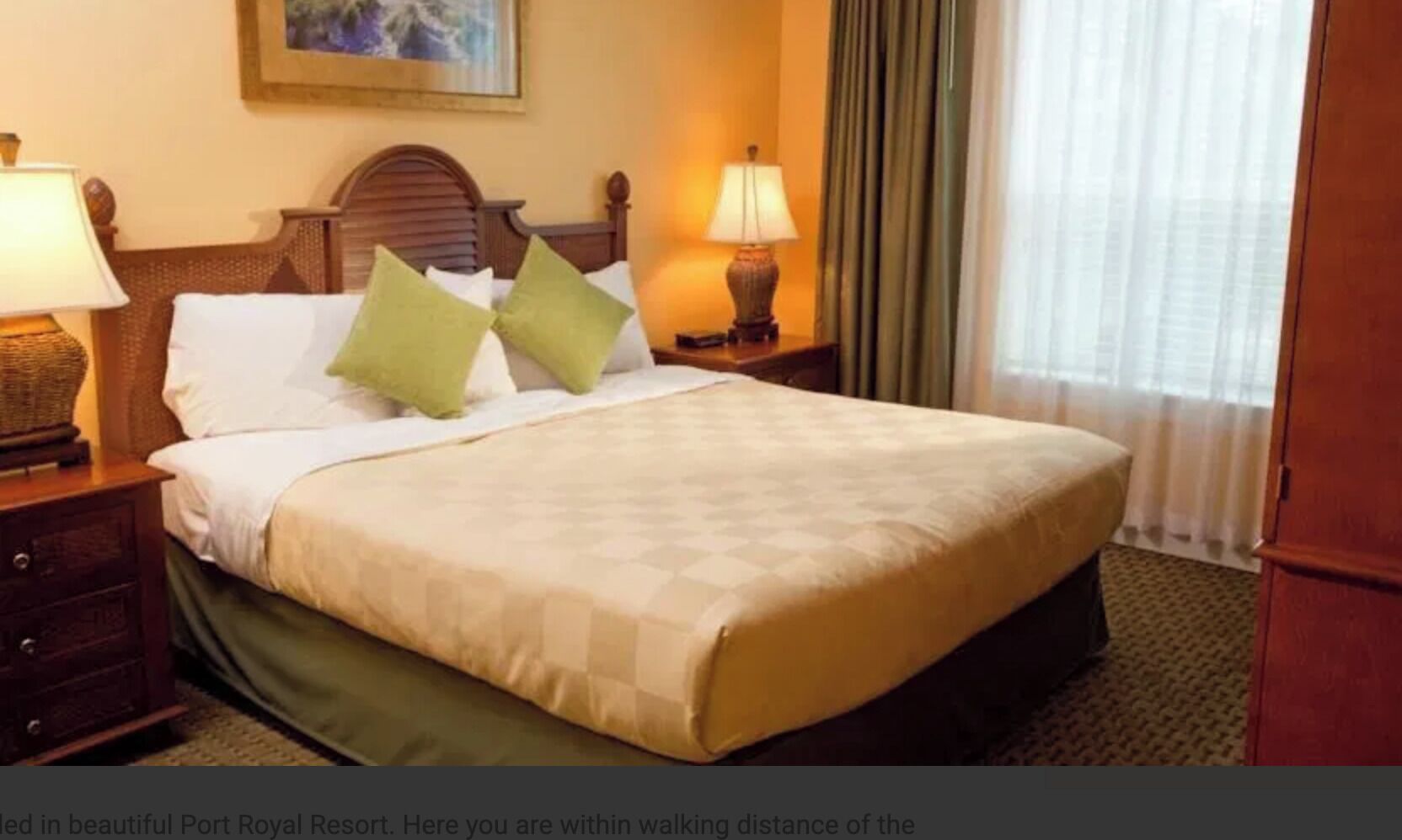 A hotel room with a large bed, two bedside lamps, a wooden headboard, and a view of a window with curtains.