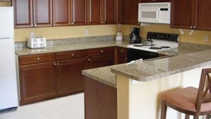 A kitchen with wooden cabinets, granite countertops, a microwave, a stove, and a toaster. - Most Relaxing Resort Hilton Head Island, SC-Close to Beach-3 Bedroom, 3 Bathroom (Hilton Head Island)