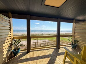 A wooden deck with a view of the beach. - The Breeze Beachfront Resort (Surfside Beach)