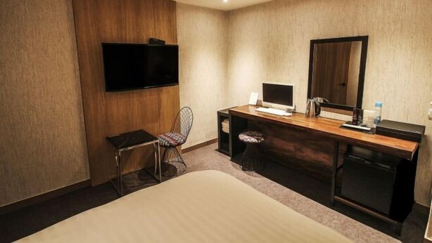 A hotel room with a bed, a desk with a computer, a chair, a television, and a mirror. - Hotel Blanc in Gangnam (Yeoksam) (Seoul)