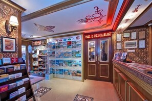A bar and restaurant with a display of various items, a ceiling with a butterfly design, and framed pictures on the walls. - Hotel Agan Oldcity Istanbul (Istanbul)