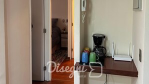 A small kitchenette with a coffee maker, mugs, and a Wi-Fi router. - Disegni 17 - Santiago Apartment, Close to Metro and Culture (Santiago)
