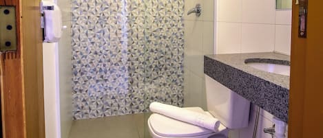 A bathroom with a shower, toilet, and sink.
